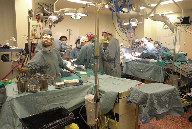 Doctors performing surgery on seven-month-old twins Tinashe and Tinotenda Mufuka in an operating room at The Hospital for Sick Children