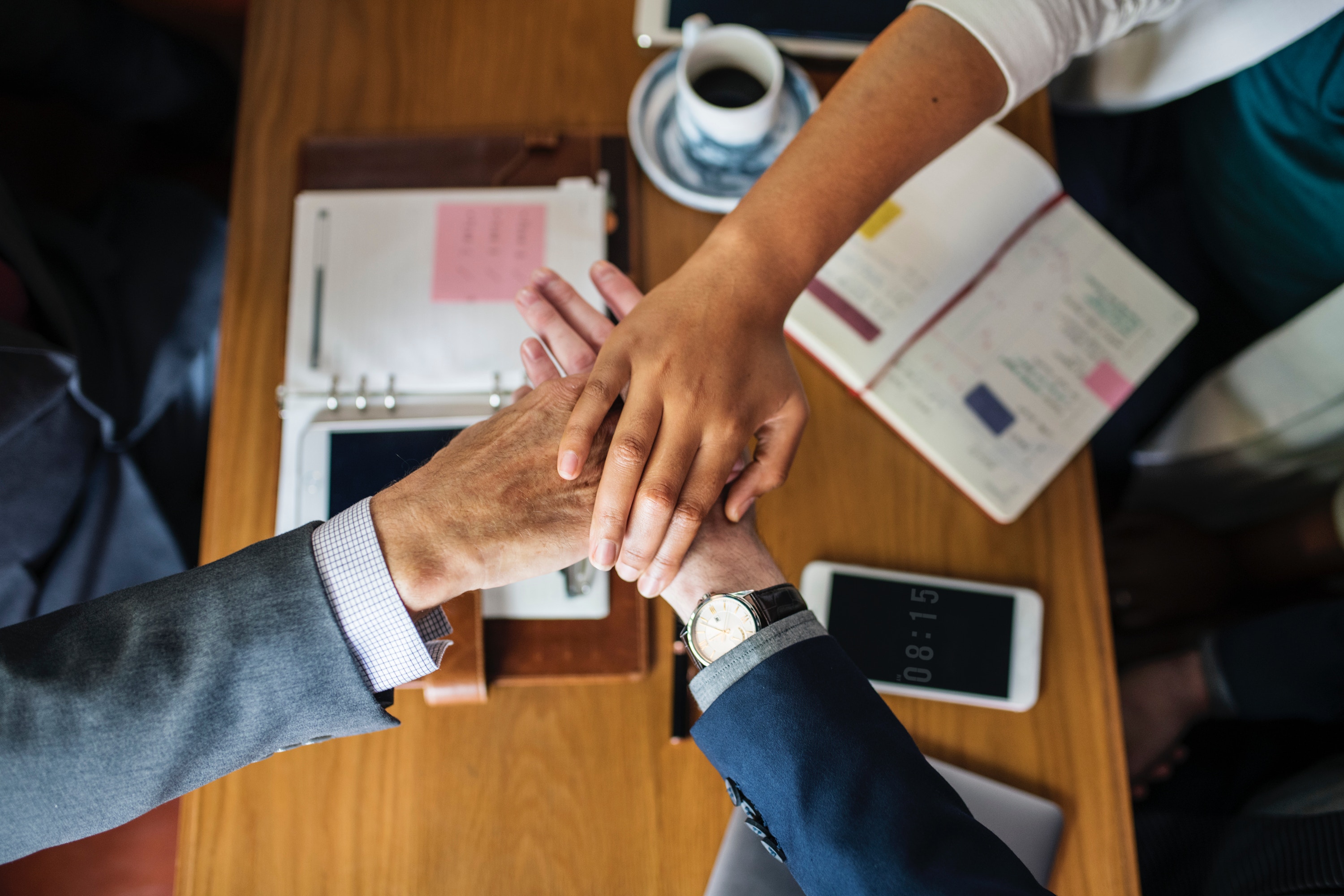 Photo of 3 hands on top of one another