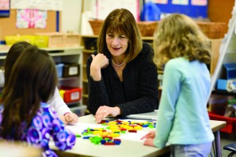 Researcher Joan Moss works with young ICS students on algebra. Experts cite the late introduction of algebra as the biggest cause of math failure in high school