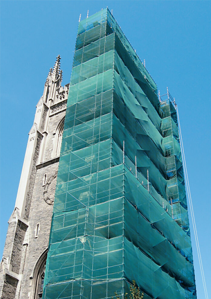 Restoration project scaffolding covered in green material run along one side of Soldiers' Tower