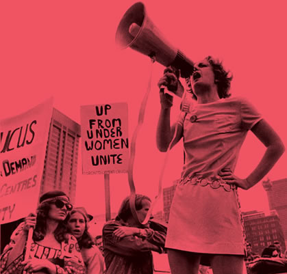 Photo of woman with a megaphone at a protest.