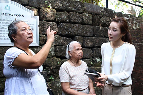 Photo of Jennifer Moon interviewing two women.