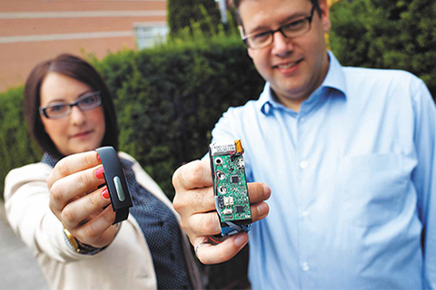 Bionym co-founders Foteini Agrafioti (left) and Karl Martin display the Nymi wristband.