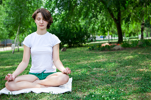 Photo of a woman meditating.