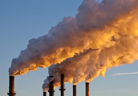 Photo of billowing smokestacks.