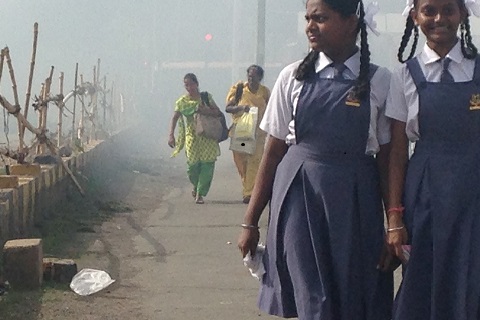 Construction smoke wreathes a bridge in Mumbai