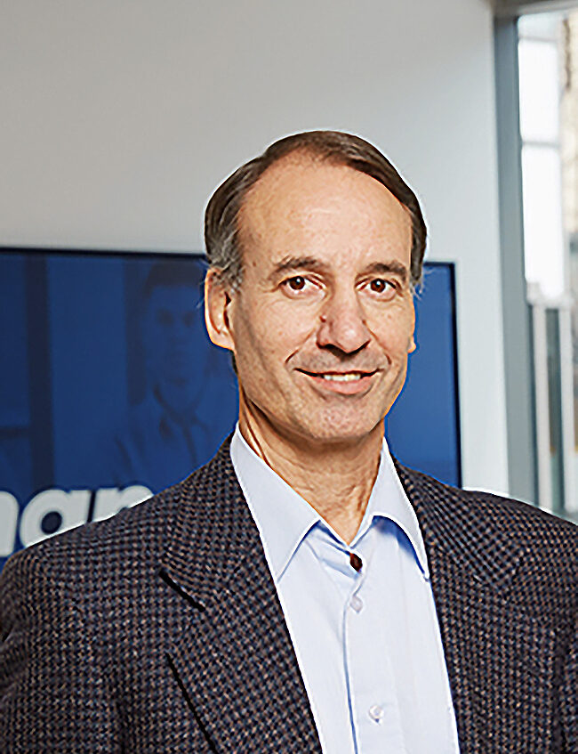 Close-up photo of David Scrymgeour in a grey tweed blazer and collared shirt