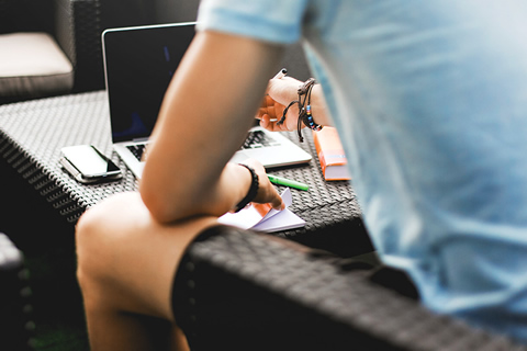 Photo of a man sitting at a computer.