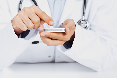 Photo of a doctor with a mobile phone.