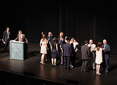 Photo of graduates on stage receiving their stethoscopes