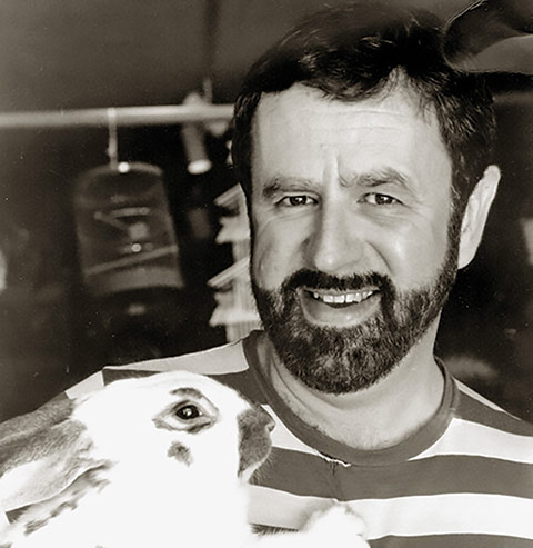 Black and white photo of Jack Hallam with a rabbit