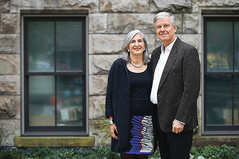 Photo of Catharine Tanner and Jamie Goad with the wall of a building as a backdrop