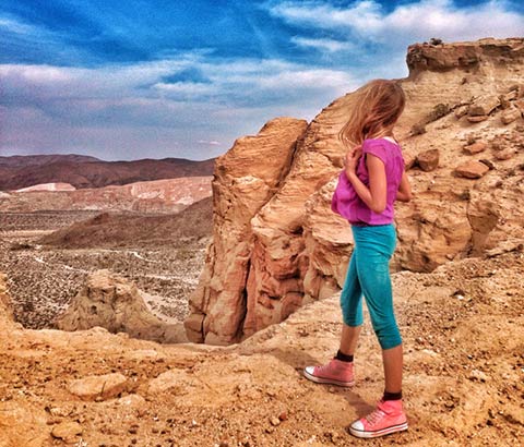 Photo of girl looking out across a canyon