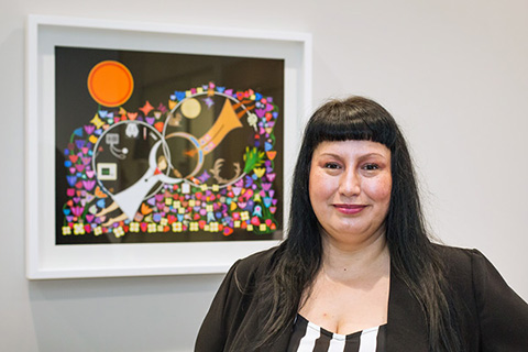 Headshot of Lisa Boivin in front of a digital painting