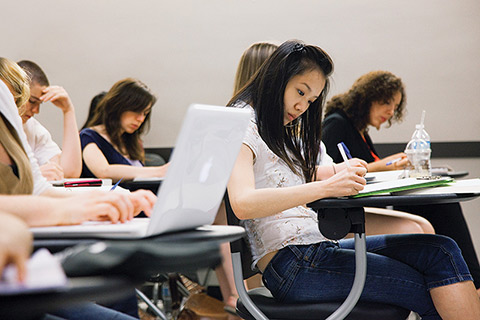 Photo of students taking notes in class