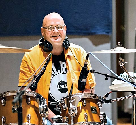 Photo of Jim Delaney with a drum set