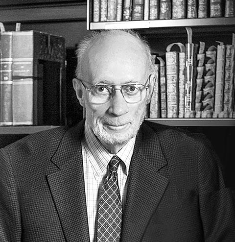 Photo of Russell J. Morrison in front of a bookshelf