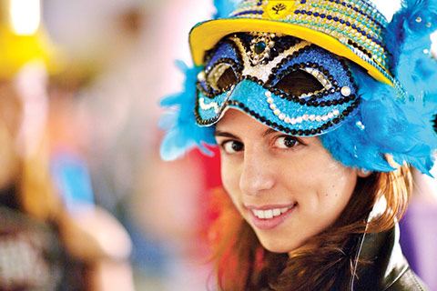 Close-up photo of Stephanie Gaglione with a blue, feathered mask