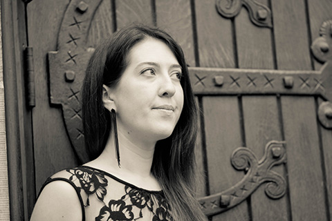 Closeup photo of Olivia Shortt against a wooden door