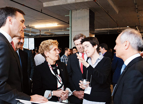 Prof. Raquel Urtasun talks about her AI research with Minister of Finance Bill Morneau, Premier Kathleen Wynne, Mayor John Tory and U of T president Meric Gertler