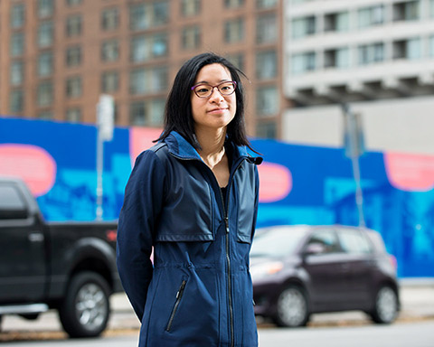 Ellen Tang in front of the St. John’s Ward exhibit in downtown Toronto