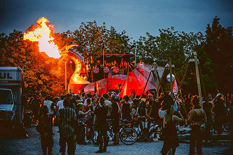 Photo of dragon breathing fire surrounded by a crowd of onlookers.