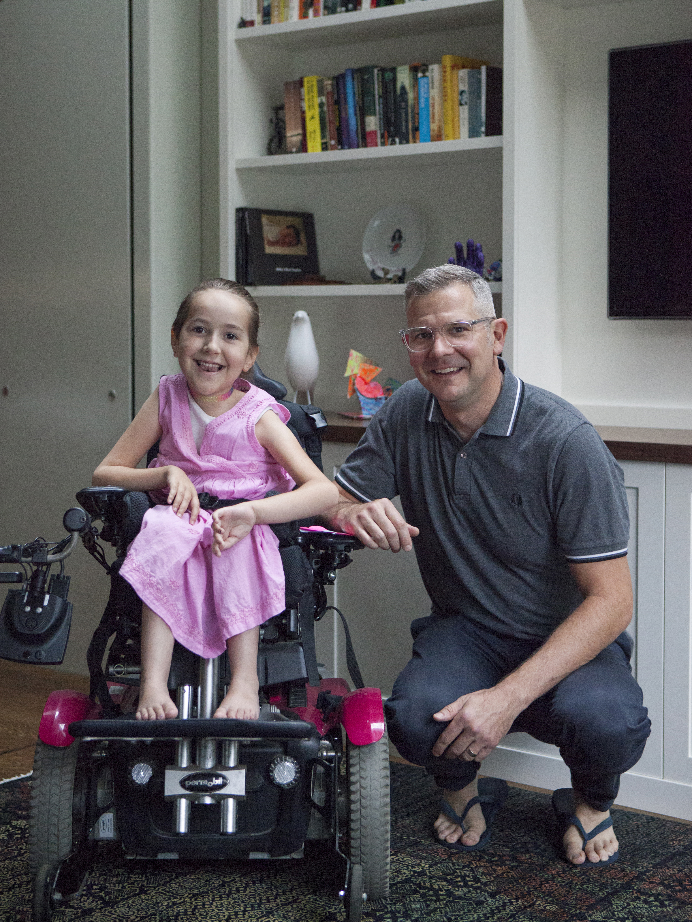 Portrait of Ron Buliung kneeling beside his daughter Asha