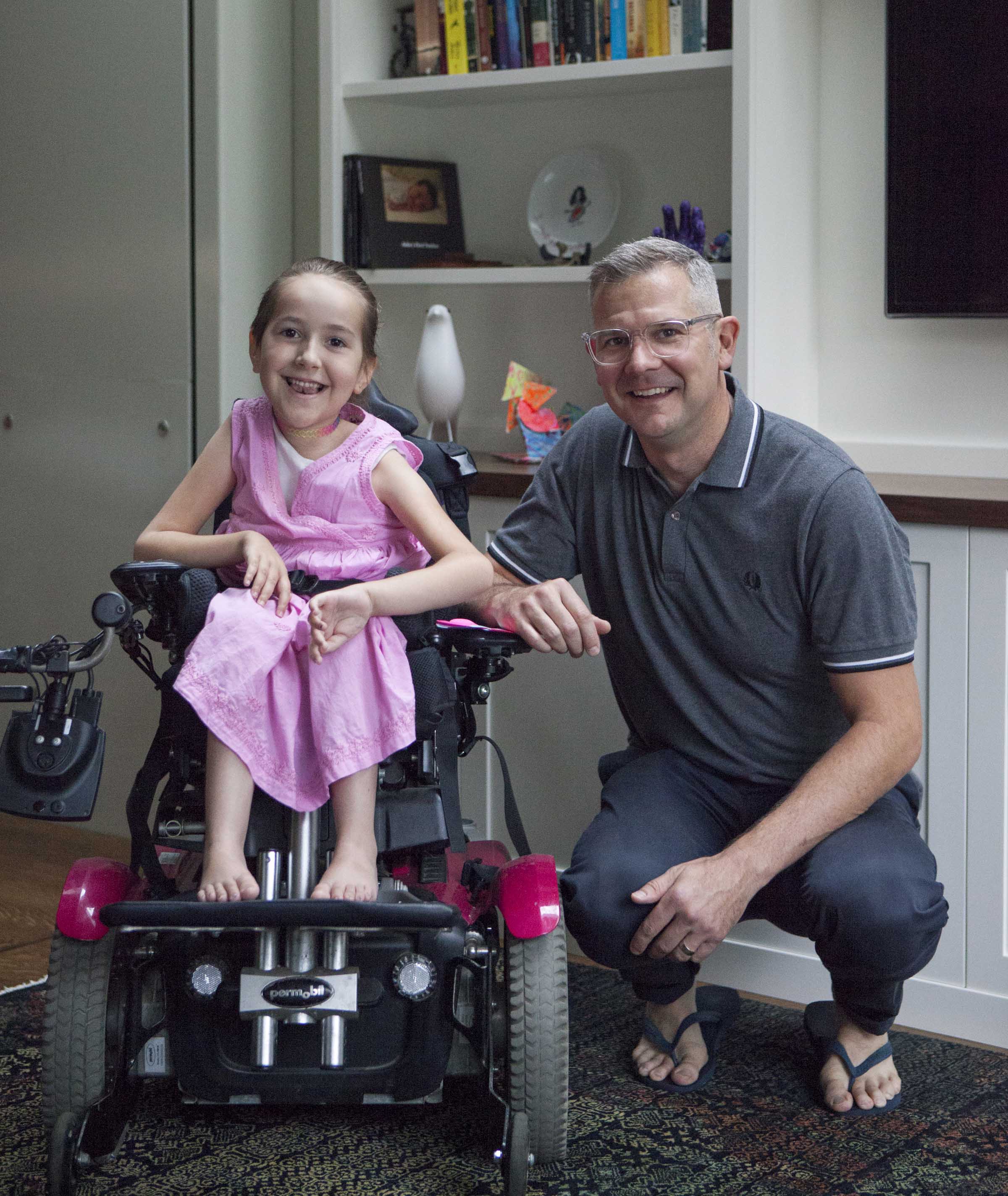 Portrait of Ron Buliung kneeling beside his daughter Asha