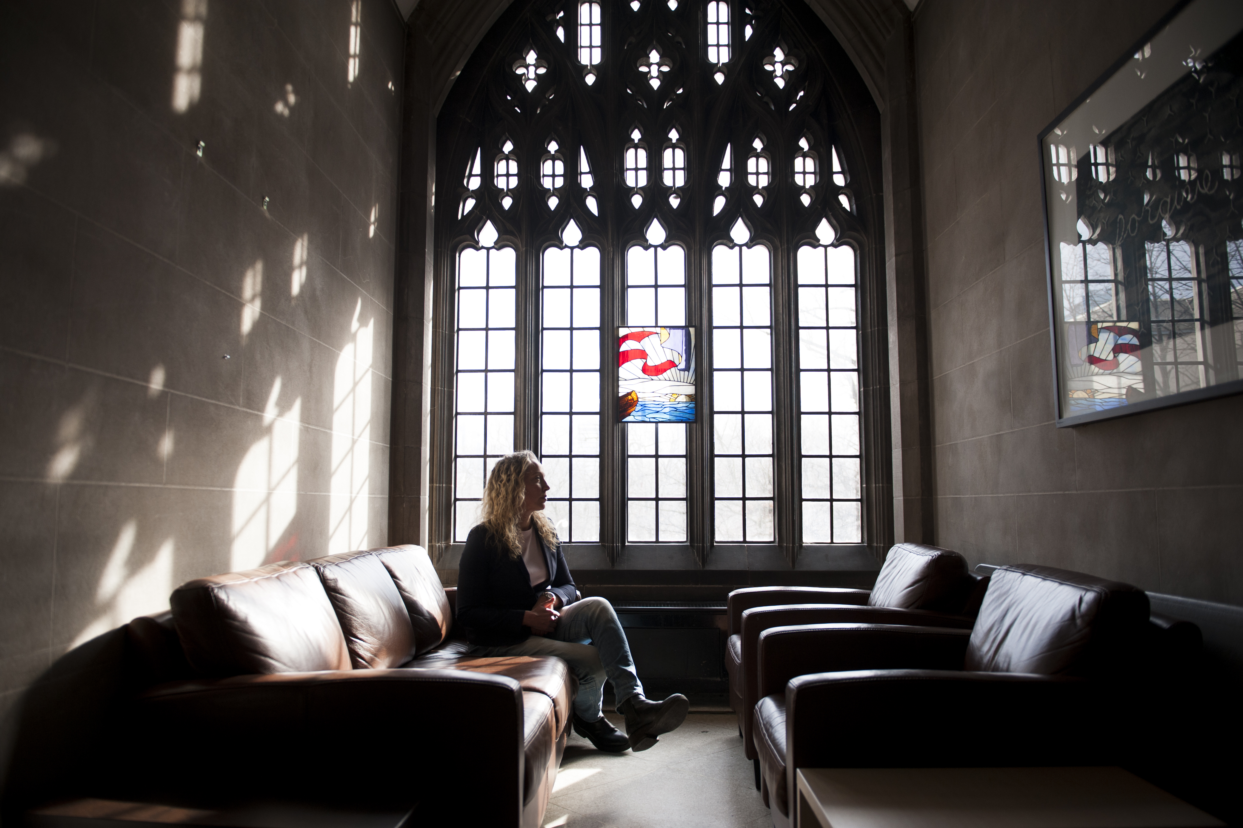 Rebecca Wittmann sits beside a window