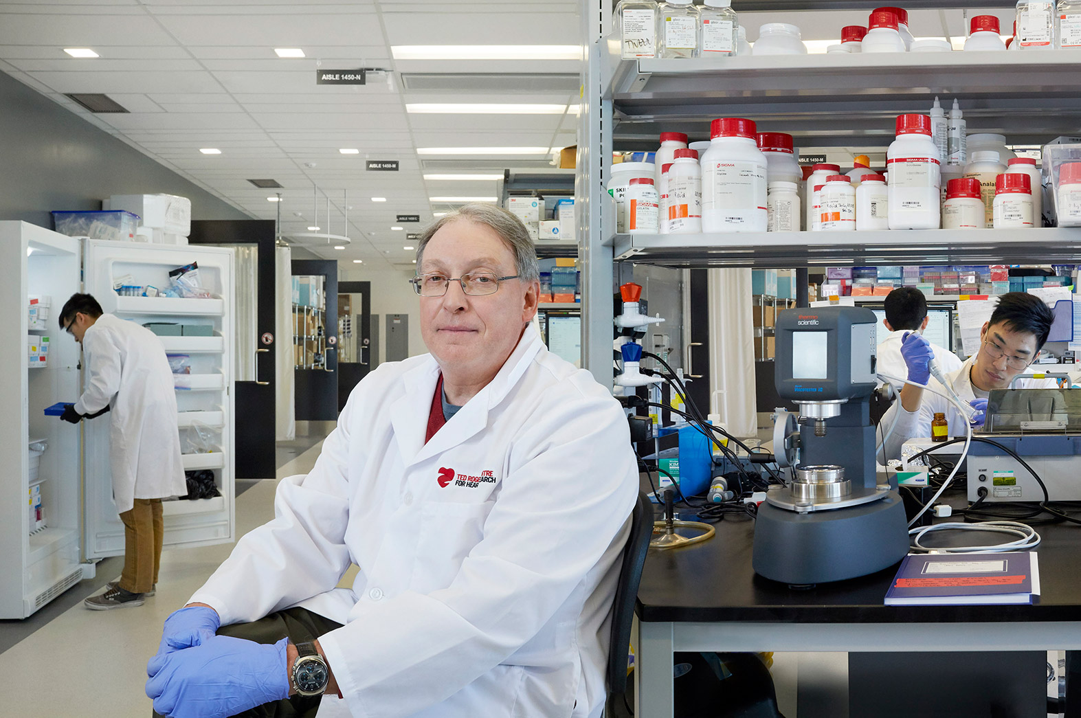 Prof. Paul Santerre in his lab at the Ted Rogers Centre for Heart Research, with his research team working in the background