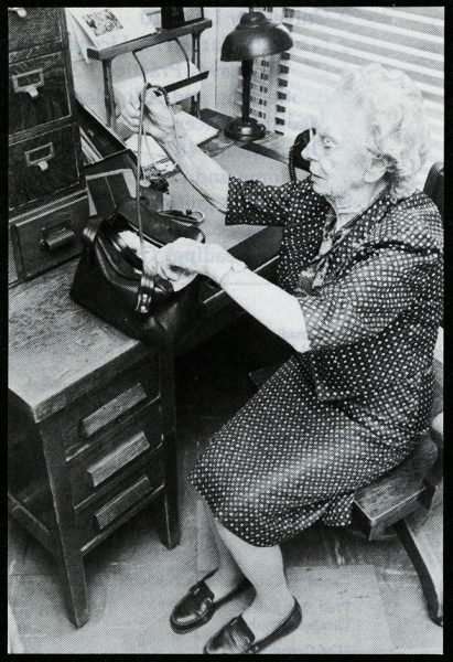 Dr. Elizabeth Bagshaw sits at a desk and packs her medical bag to go on house calls.