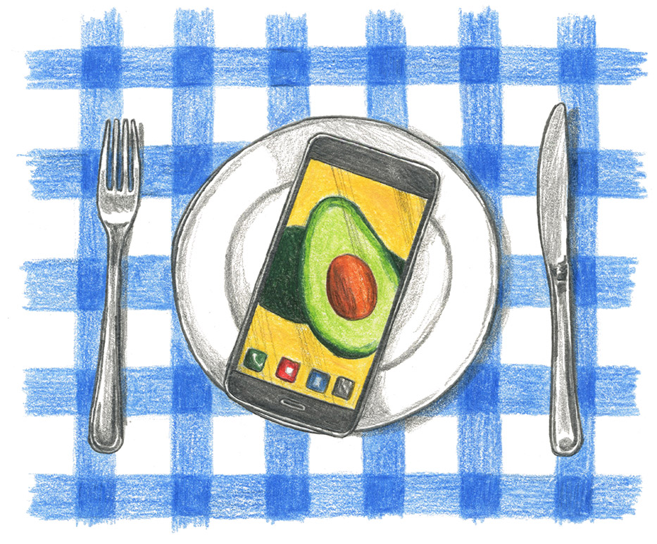 A fork, plate and knife are set out over a blue and white checkered tablecloth, with a cellphone on top of the plate with a picture of an avocado on the screen