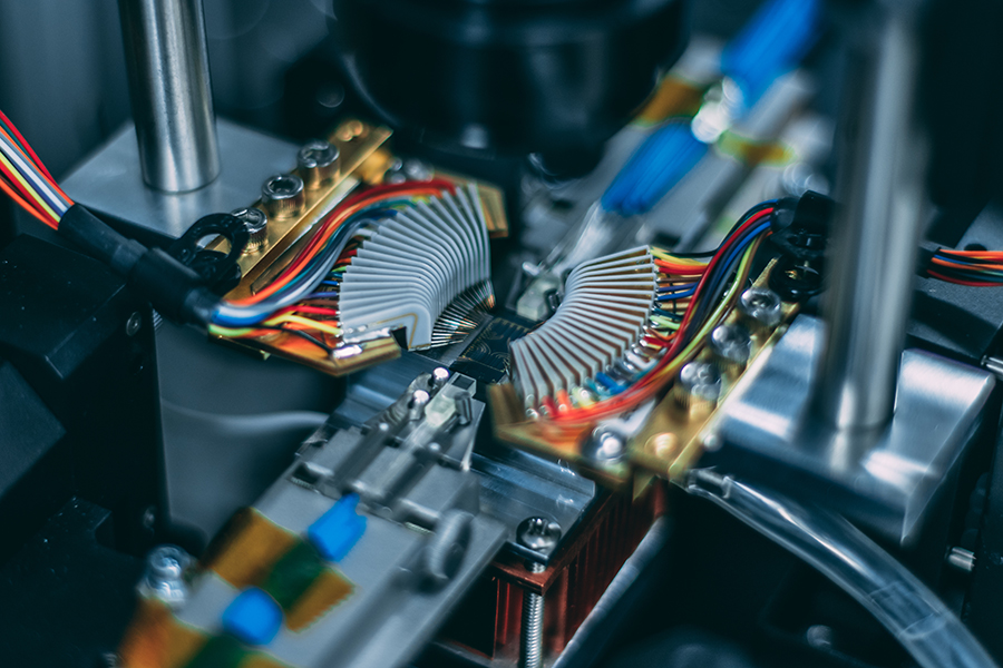 Close up photo of a quantum computer part containing different-coloured wires