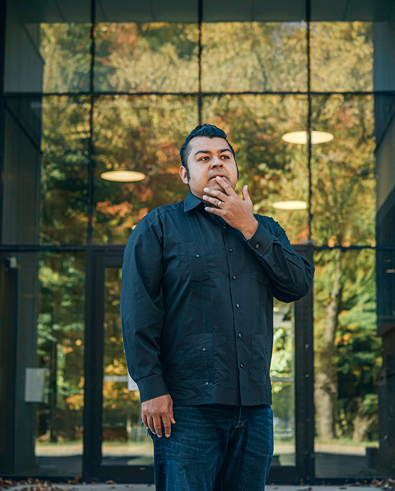 Prof. Jerry Flores standing outside the entrance of a building