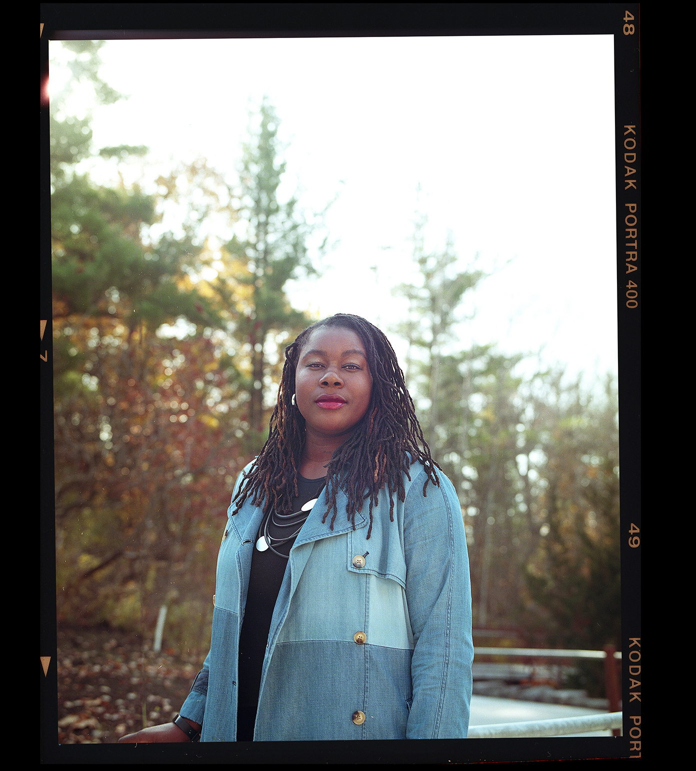 Raquel Russell standing on a path surrounded by trees