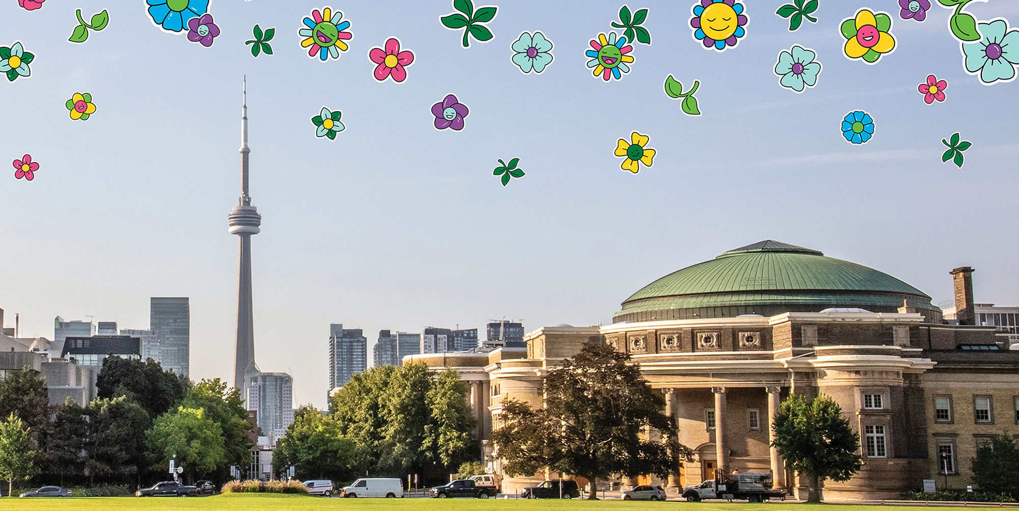 Photo of front campus field and Convocation Hall with flower emoji illustrations floating above