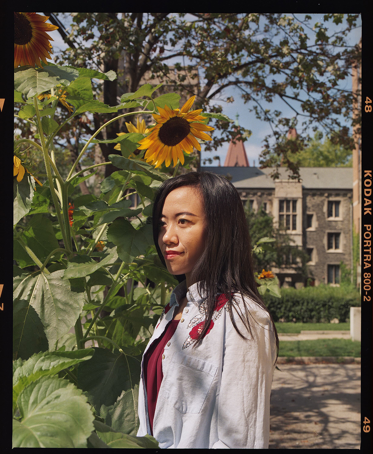 Jialiang Zhu standing next to a sunflower patch