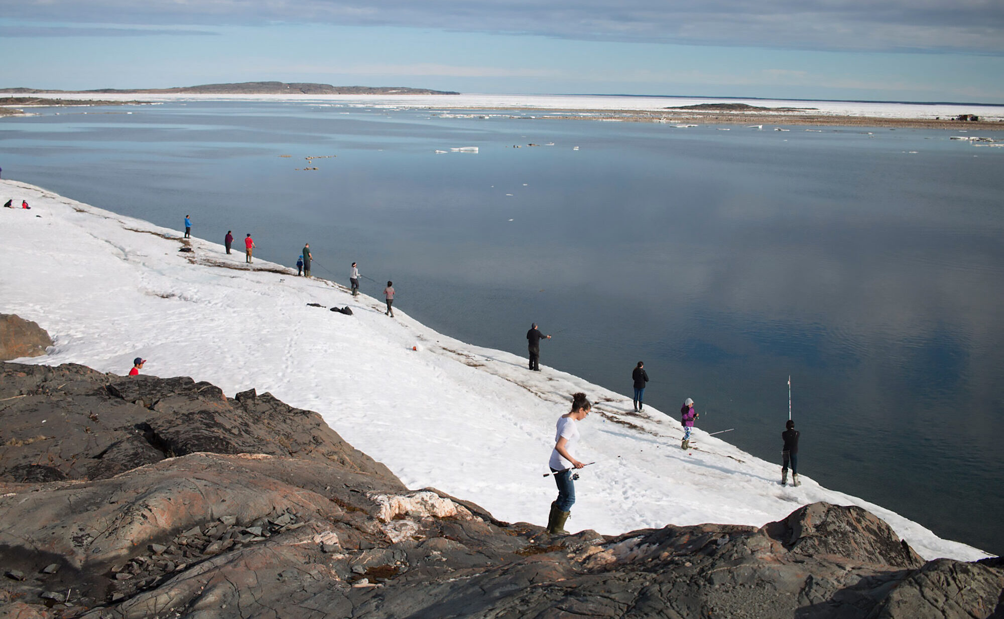 People fishing along the shoreline