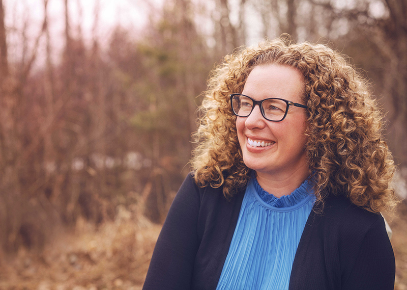 Outdoor photo of Fiona Rawle with bare shrubs in the background