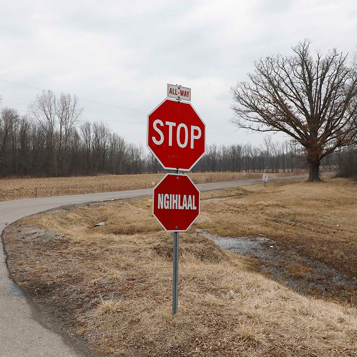 Stop sign in English and a stop sign in Munsee underneath it