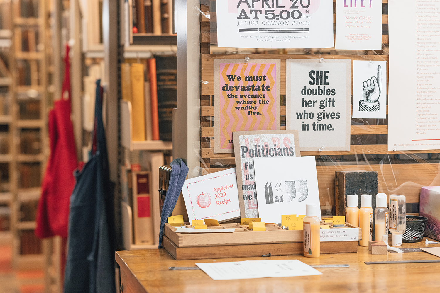 A number of posters created using a letterpress hang on a bulletin board. One of the posters says 