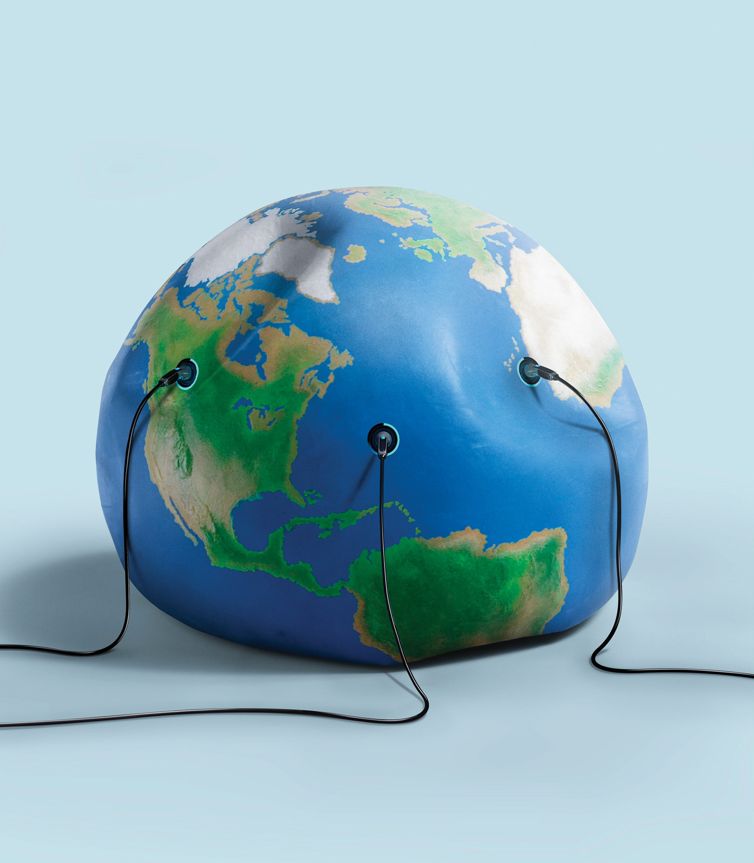 Three electric vehicle charging cables connected to a deflated globe of the Earth